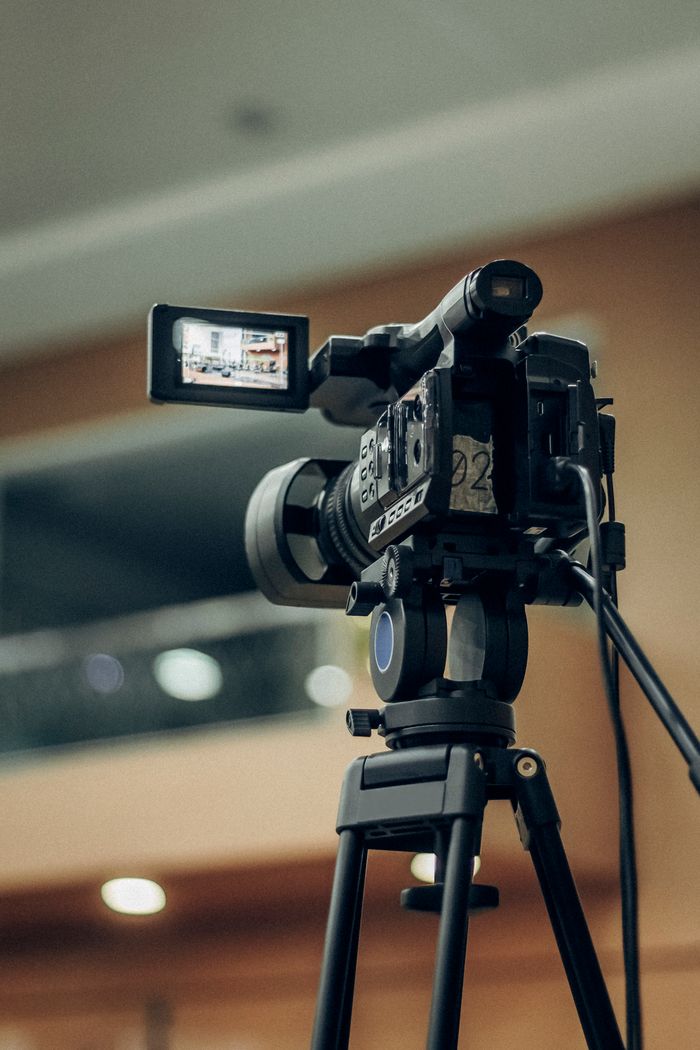 Crafting Captivating Headlines: Your awesome post title goes here A high-quality video camcorder setup on a tripod for indoor filming.